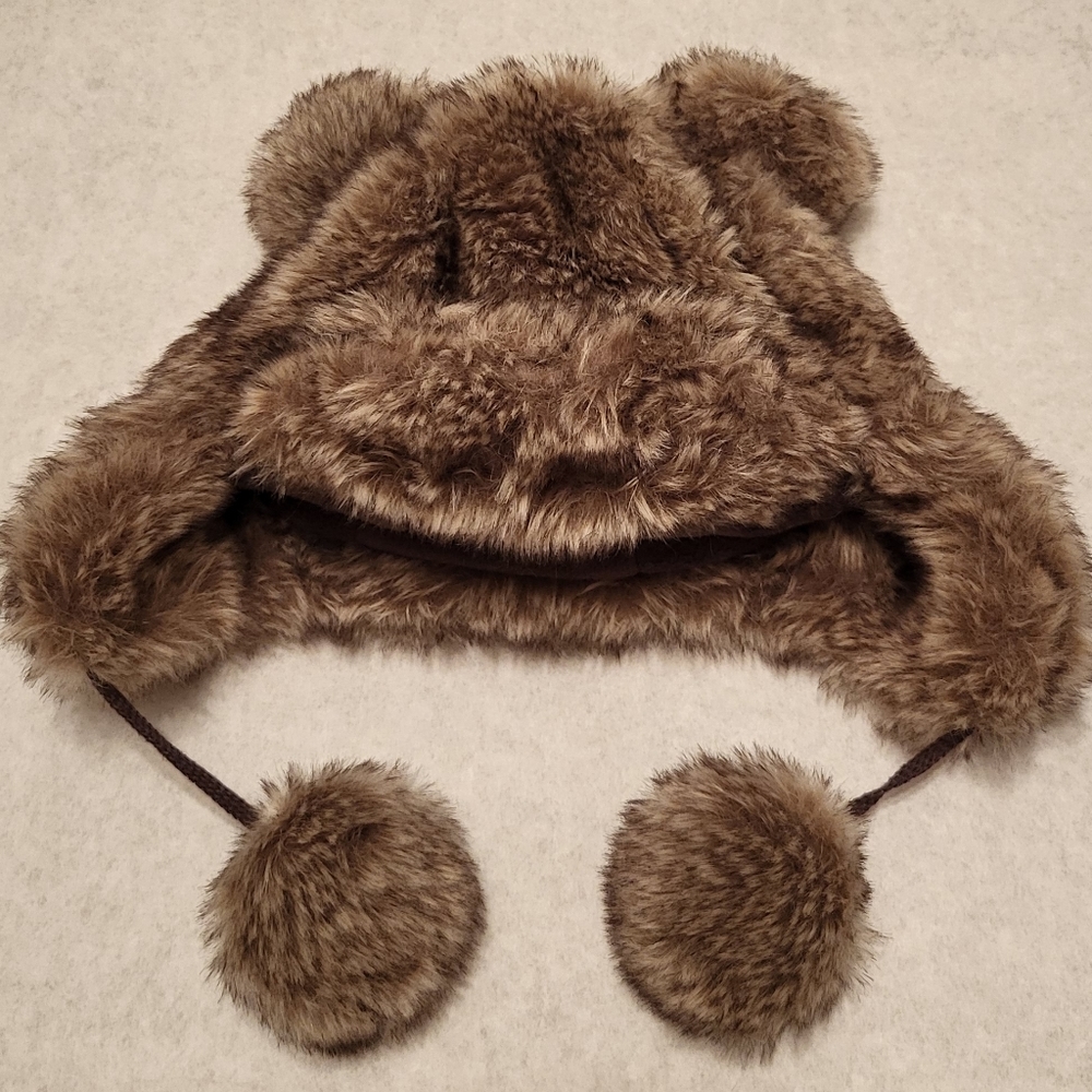 Faux fur lined winter hat with pom pom ties